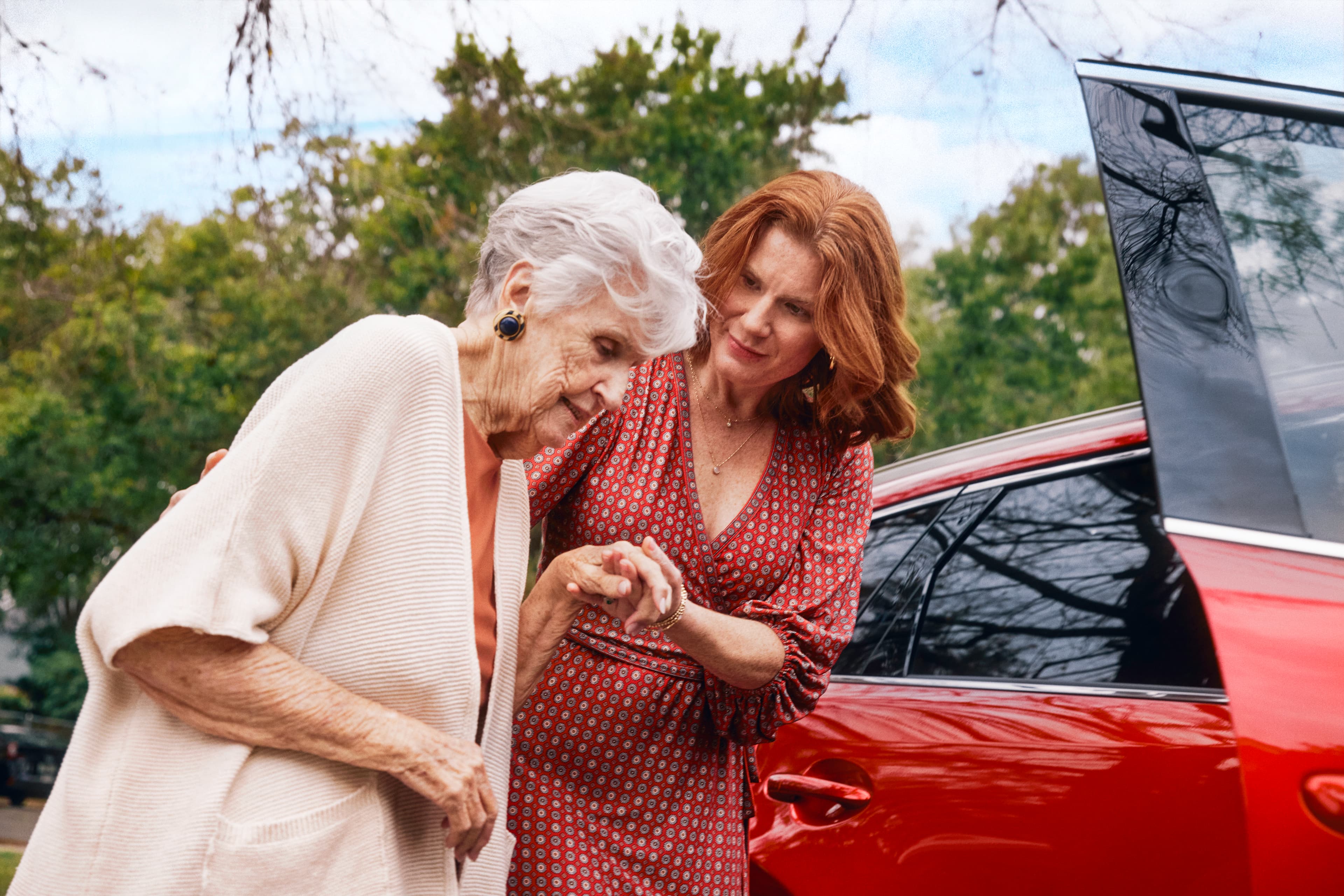 Woman helping an elderly person walk